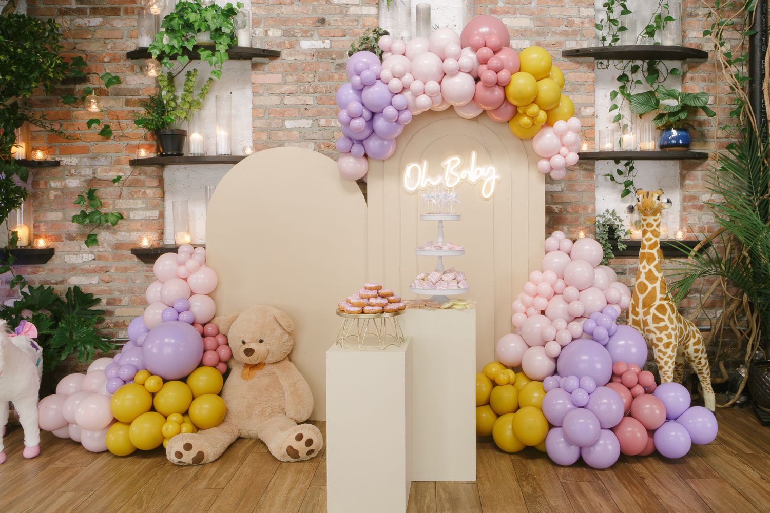 Beautiful backdrop featuring pink and purple balloons at a baby shower event, photographed by NYC photographer Paula O