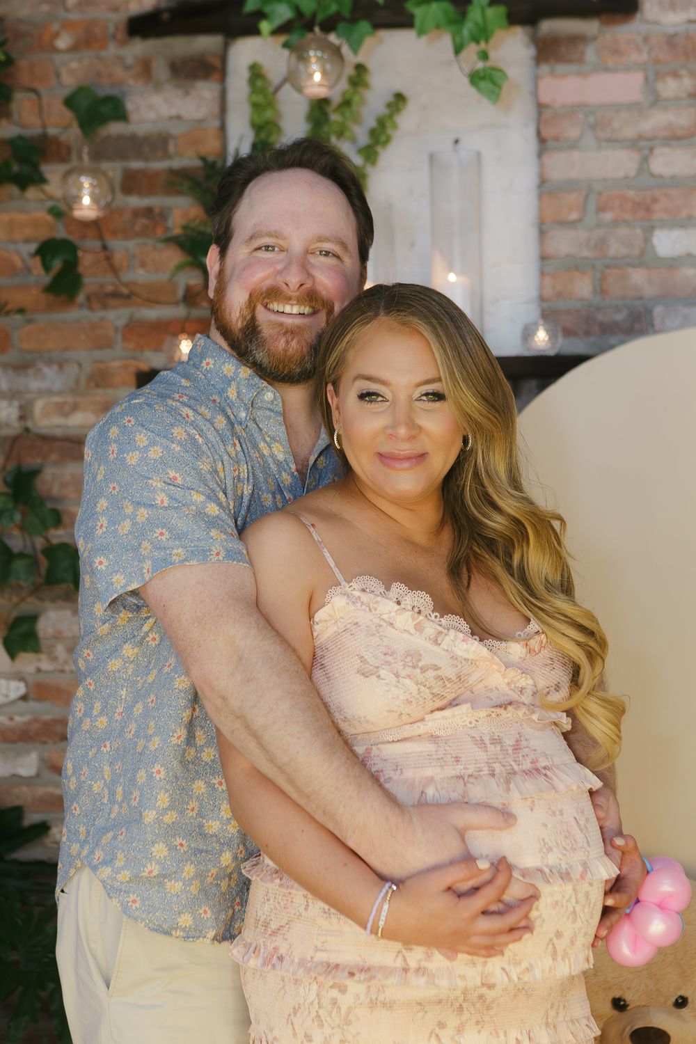 Mom and dad-to-be sharing a joyful moment at their Williamsburg baby shower, captured by Paula Ortiz