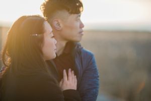 A romantic moment captured in silhouette against a sunset backdrop.