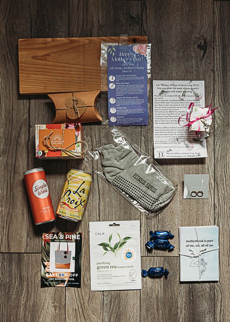 Flatlay of vintage-style items including drinks, playing cards, and printed materials on wooden surface.