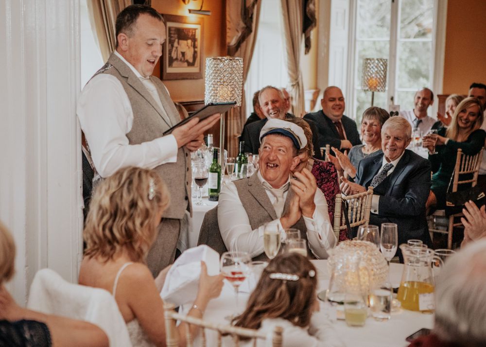 best man speech ad groom laughing at a wedding at St Elizabeth's House in Plympton