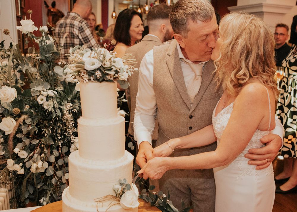 bride and groom cut the cake