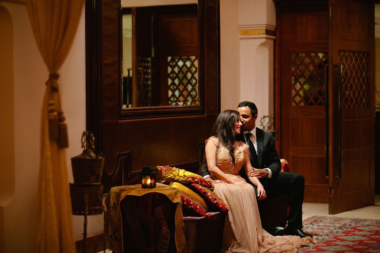 Intimate moment in a traditionally decorated room with wooden lattice windows.