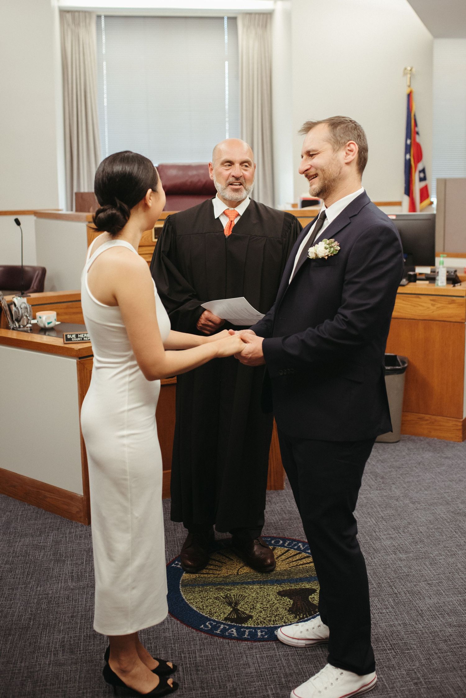 A courthouse wedding ceremony with couple exchanging vows.