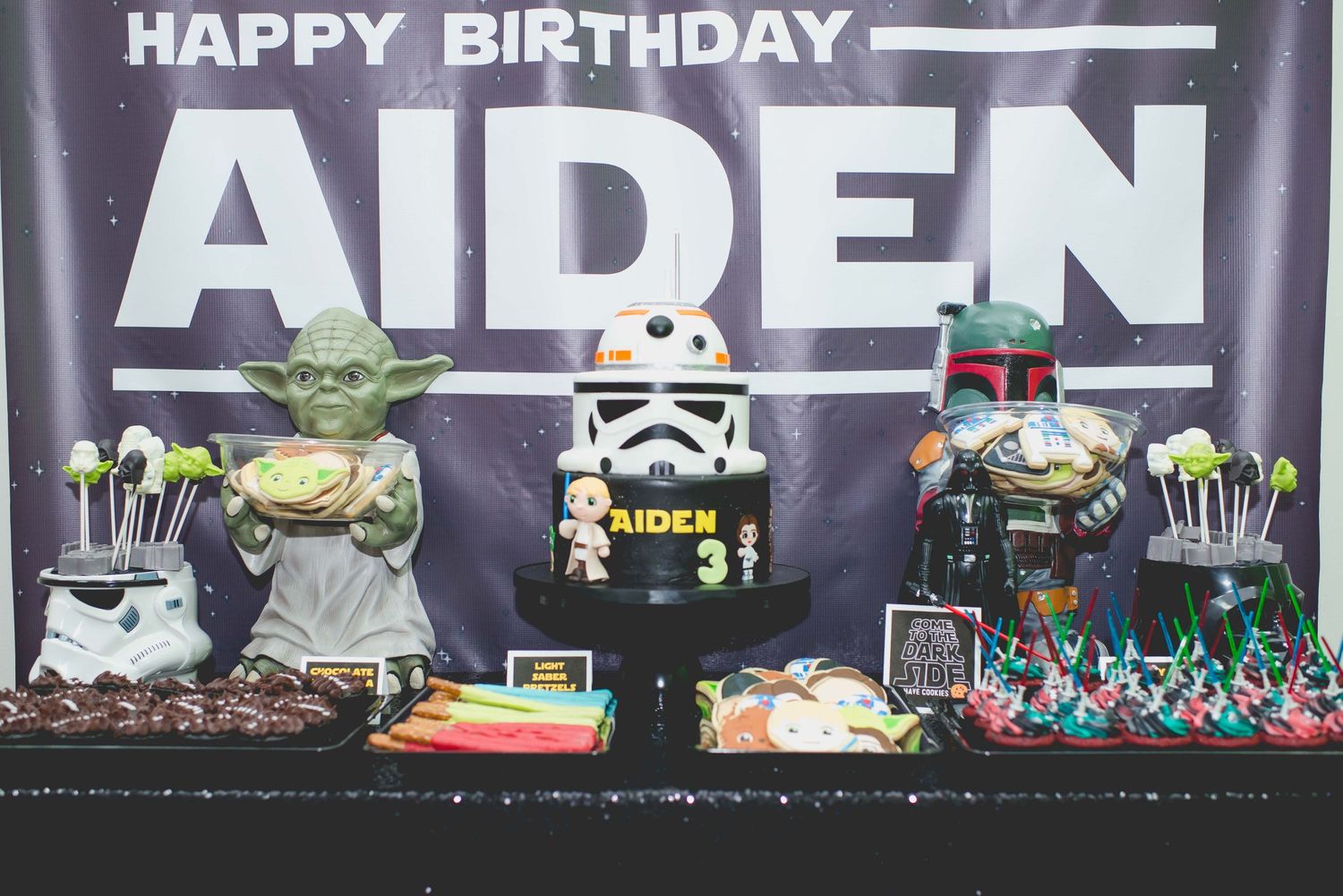 dessert table of the star wars theme birthday party with cupcakes, cookies, and cake