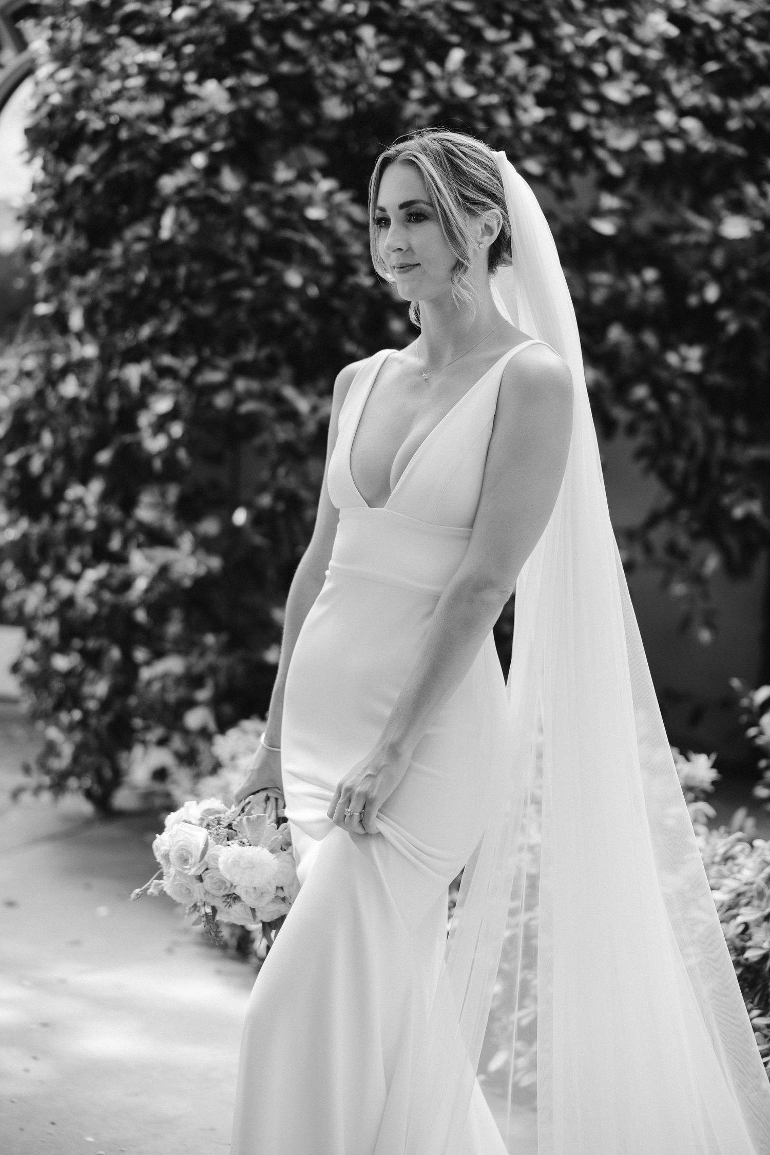 Classic black and white bridal portrait showcasing minimalist wedding gown and delicate veil.