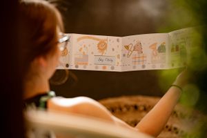 Close-up view of illustrated paper banner with cute baby-themed drawings.