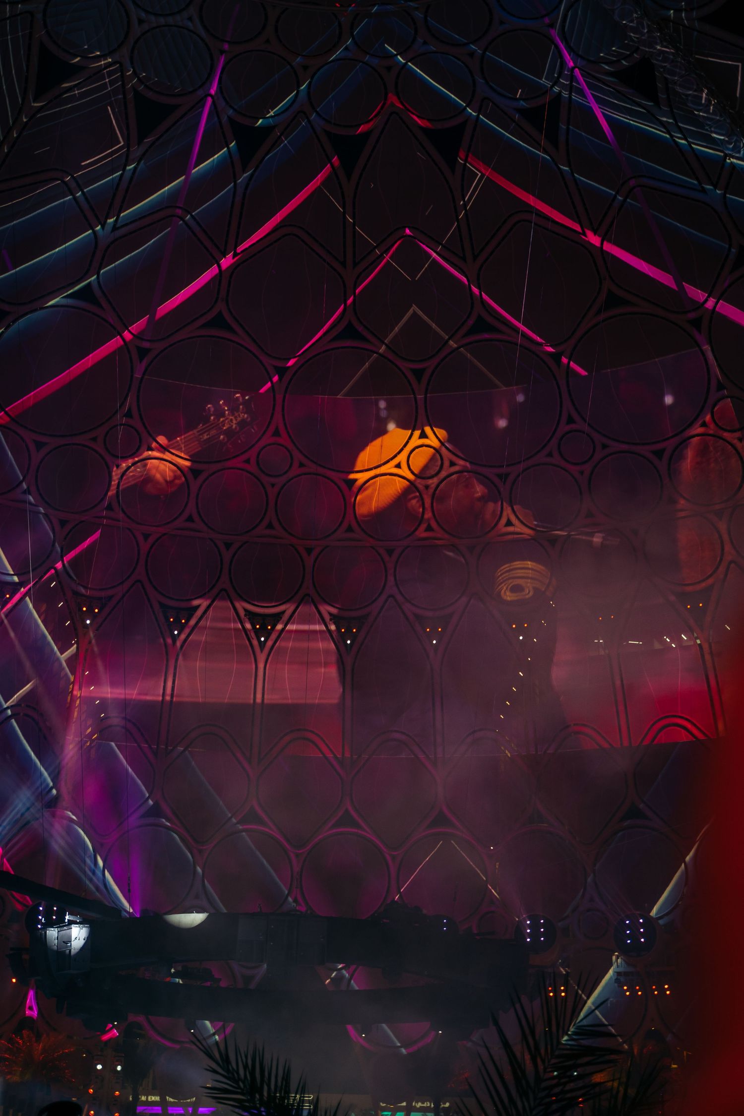 Colorful light show illuminating the geometric dome structure at Expo 2020 Dubai at night.
