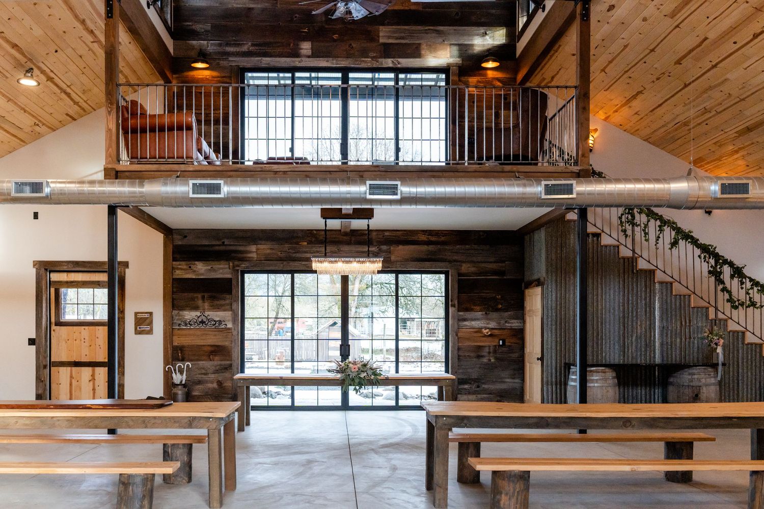 barn hall with tables and balcony
