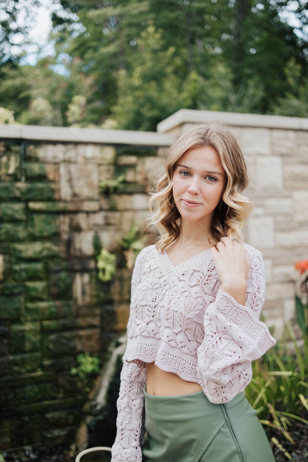 Stylish senior girl enjoying a photo session in nature