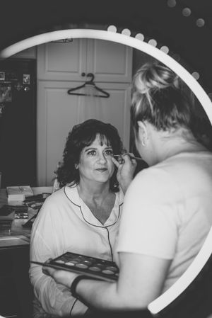 Black and white candid photos showing wedding day preparations in a dressing room.