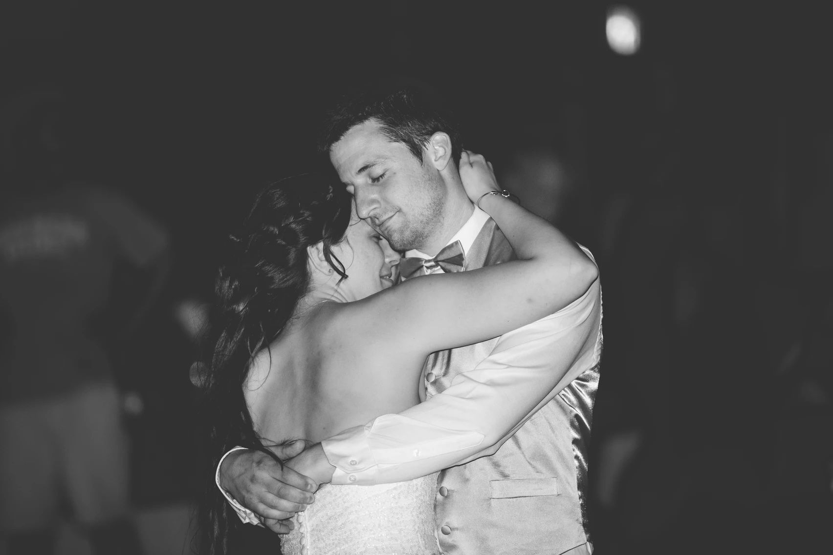 Romantic black and white dance photos capturing tender moments between newlyweds.