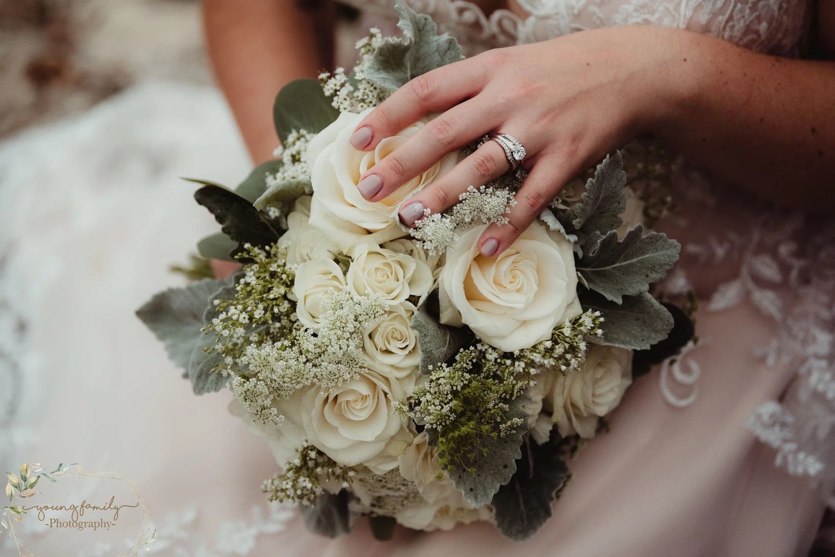 Close-up details of white rose wedding bouquets with delicate baby's breath accents.
