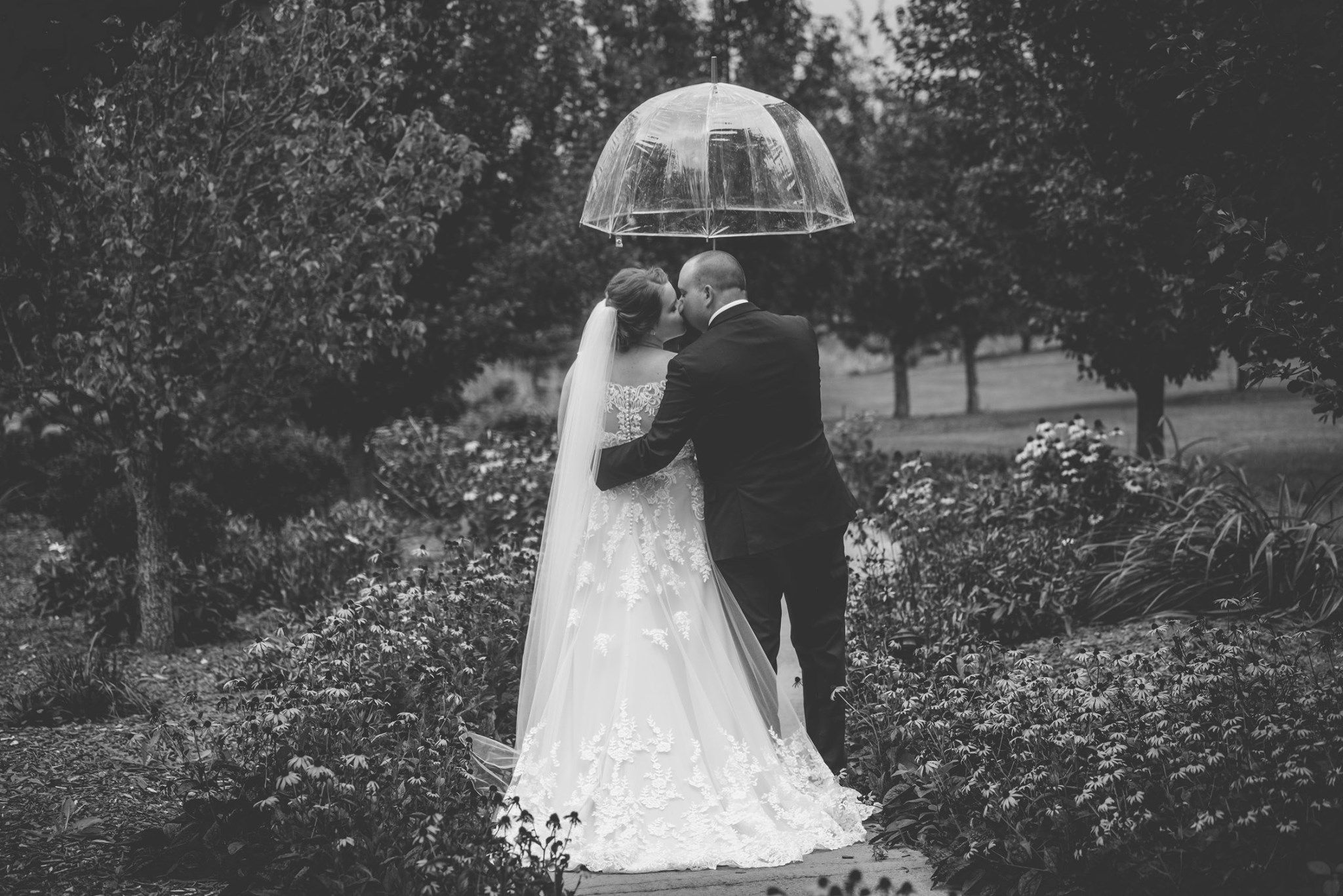 A romantic wedding photo series showing a couple walking together in a garden setting.