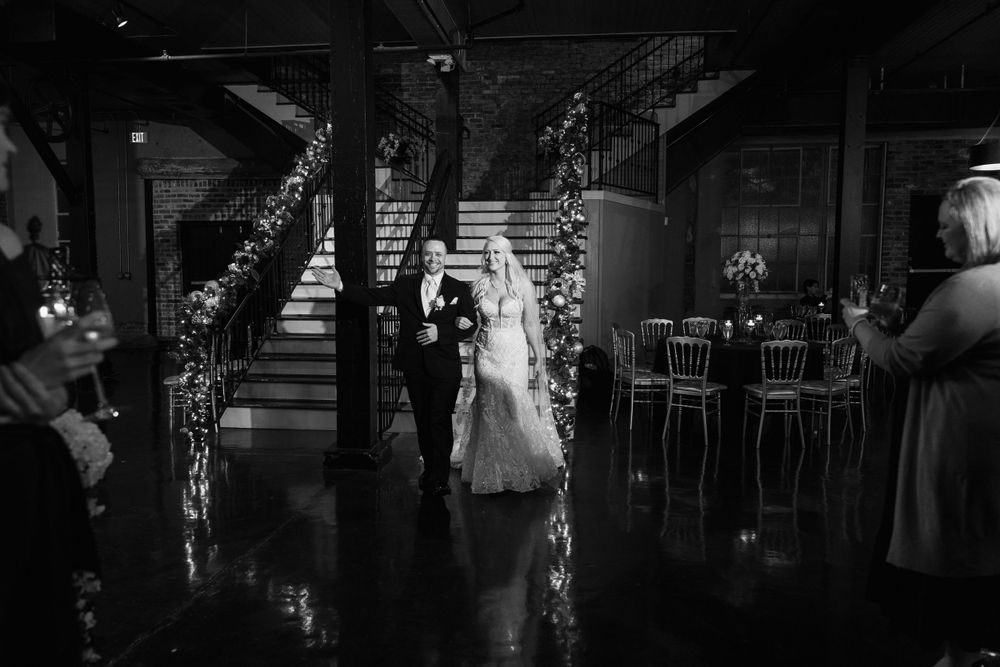 Wedding reception venue with floral arrangements and romantic mood lighting.