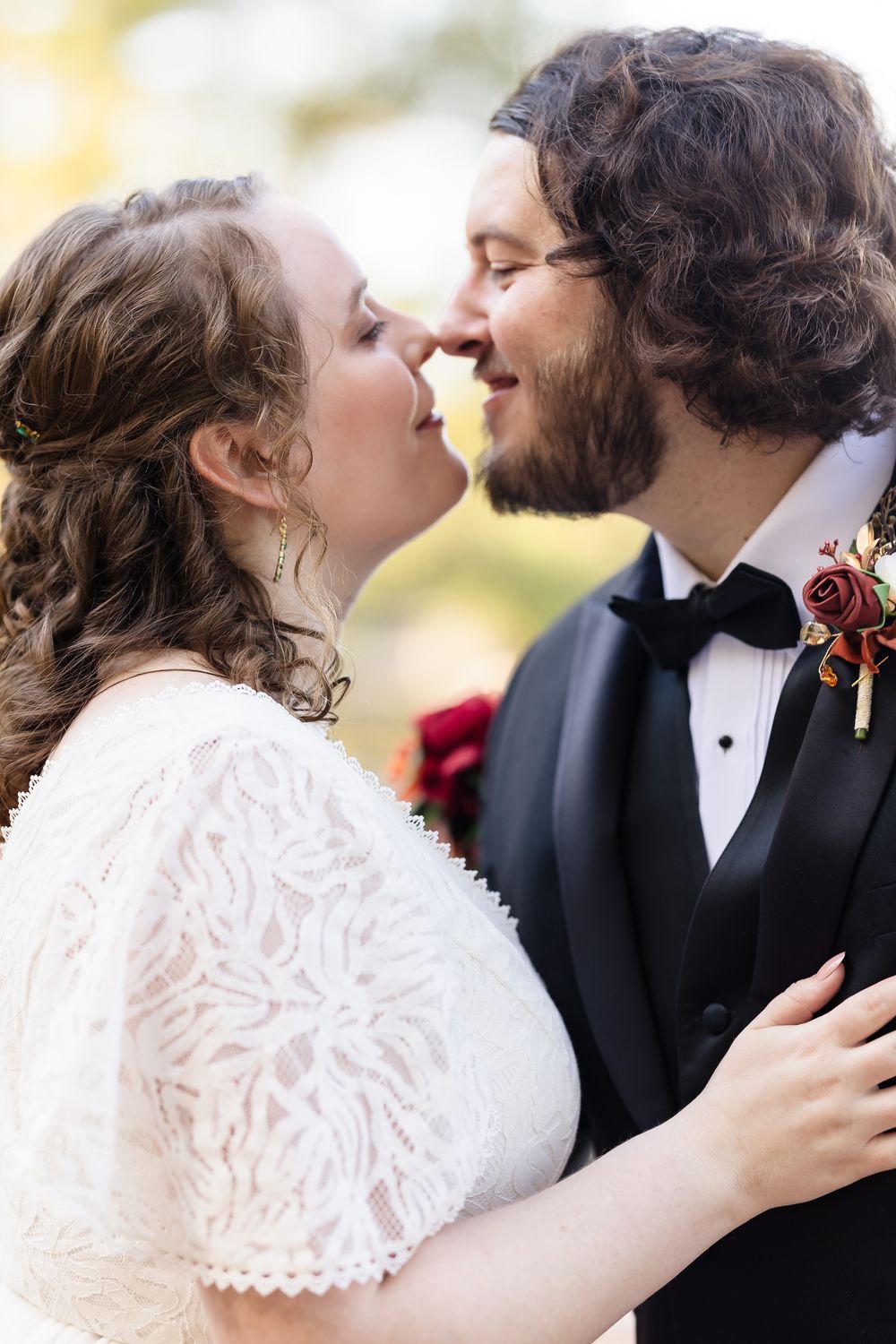 Romantic wedding portrait series showing intimate moments between bride in lace dress and groom in tuxedo.