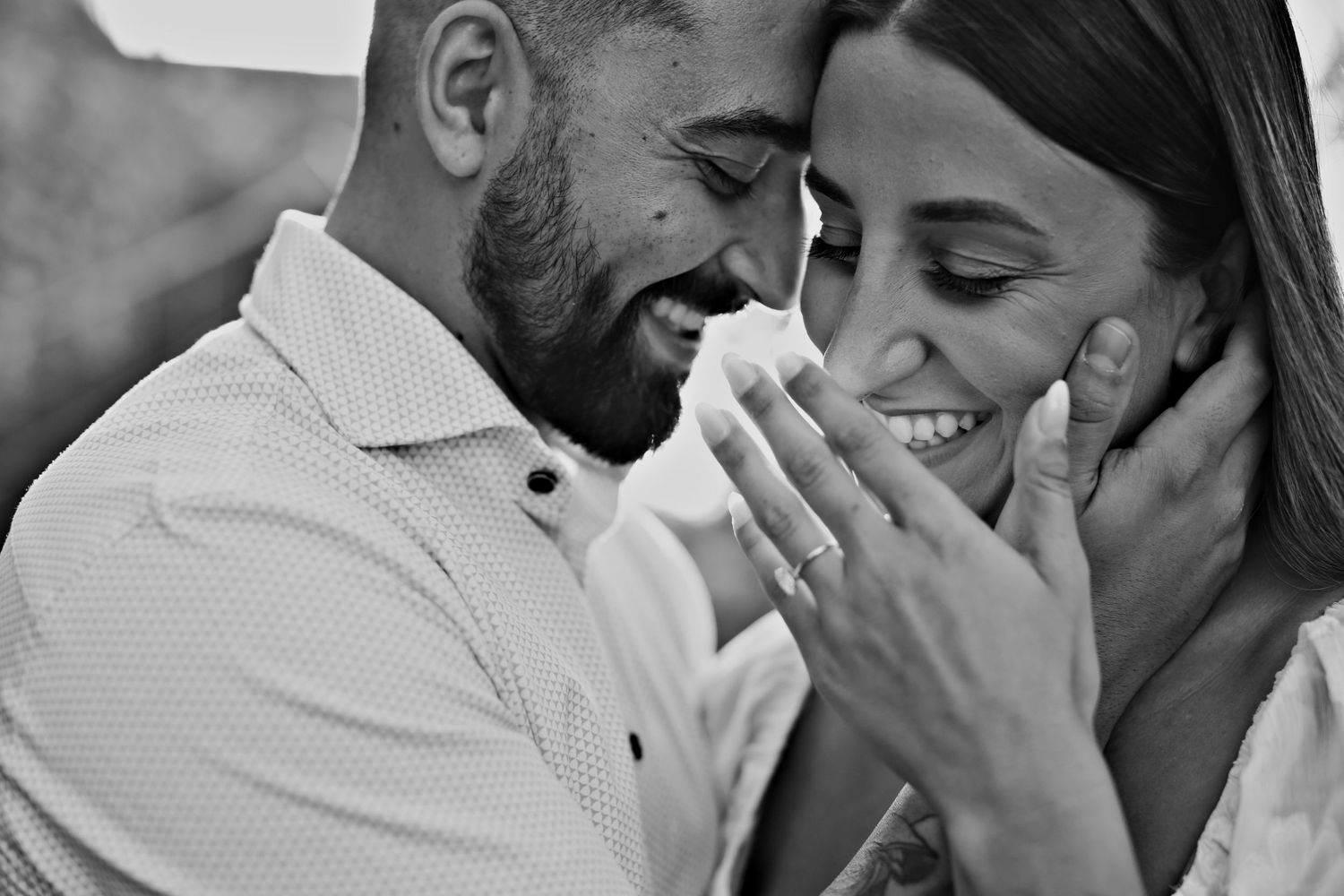 Black and white intimate portrait of a couple sharing a tender moment together.