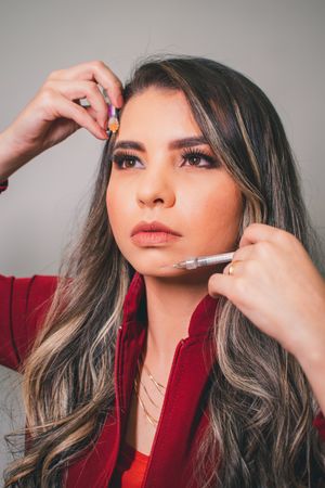 Beauty close-up with professional makeup and grey highlights in studio setting.