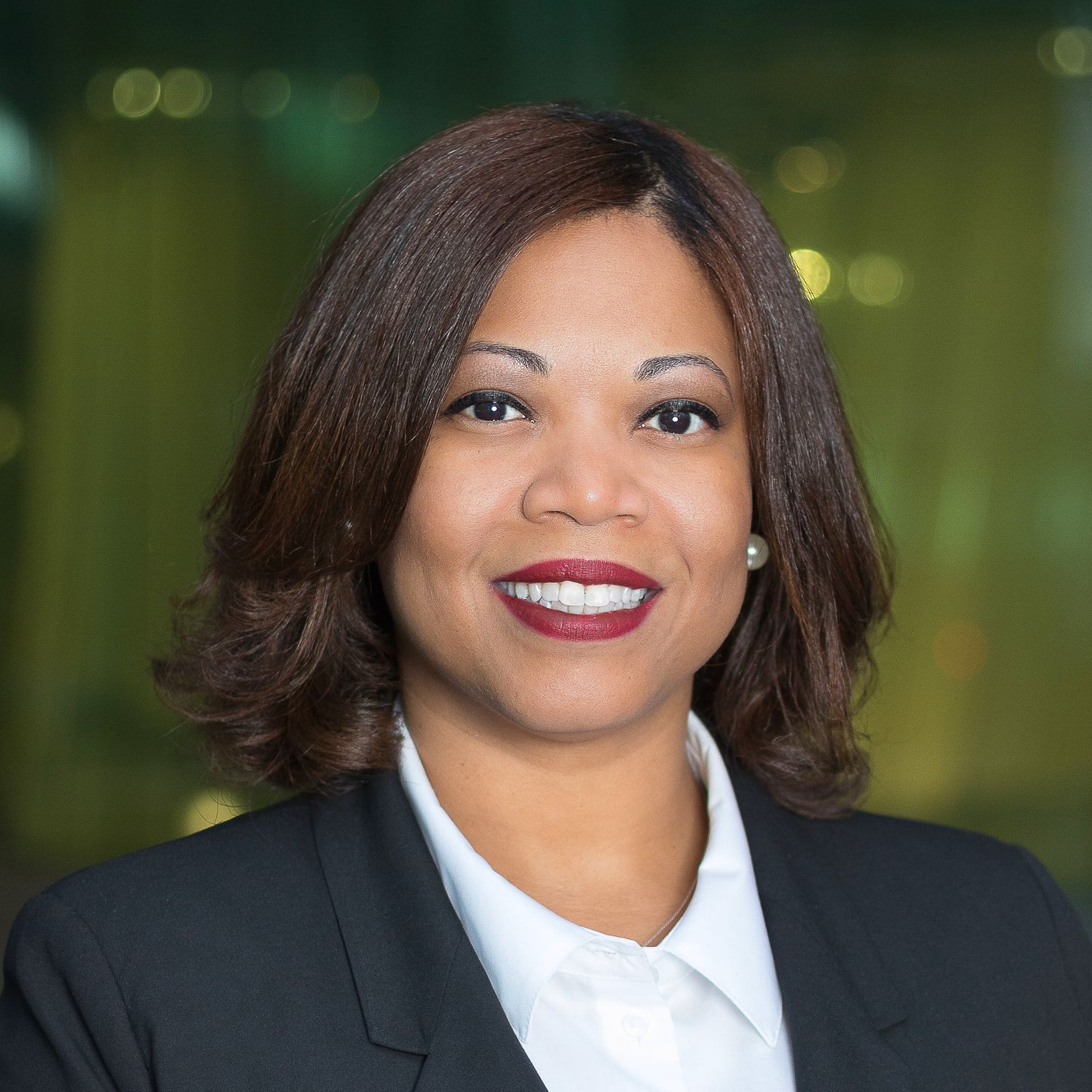 Business professional headshot of a black woman outside the Detroit Renaissance Center.