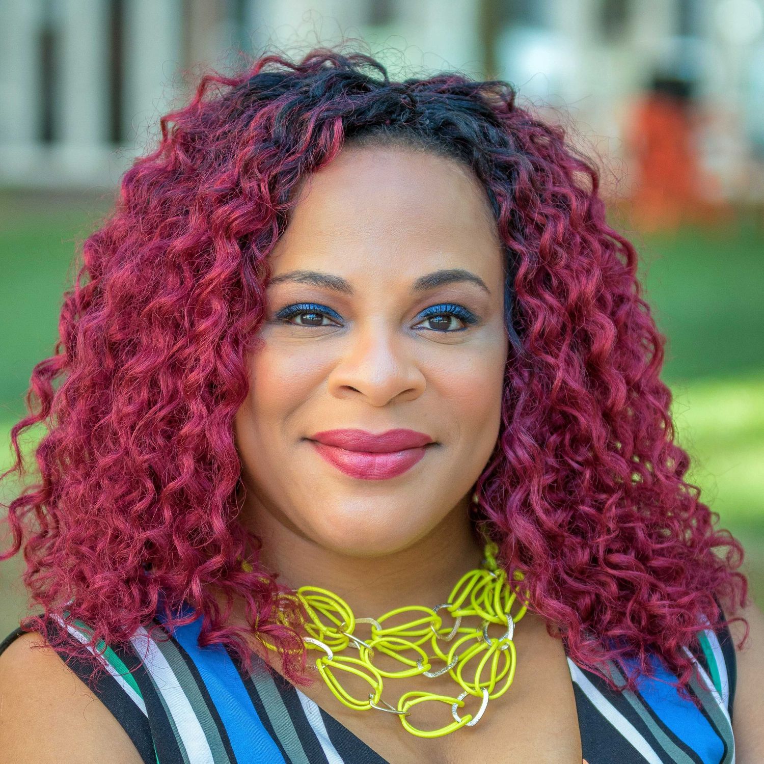 Colorful headshot of a black woman at the New Center park in Detroit.