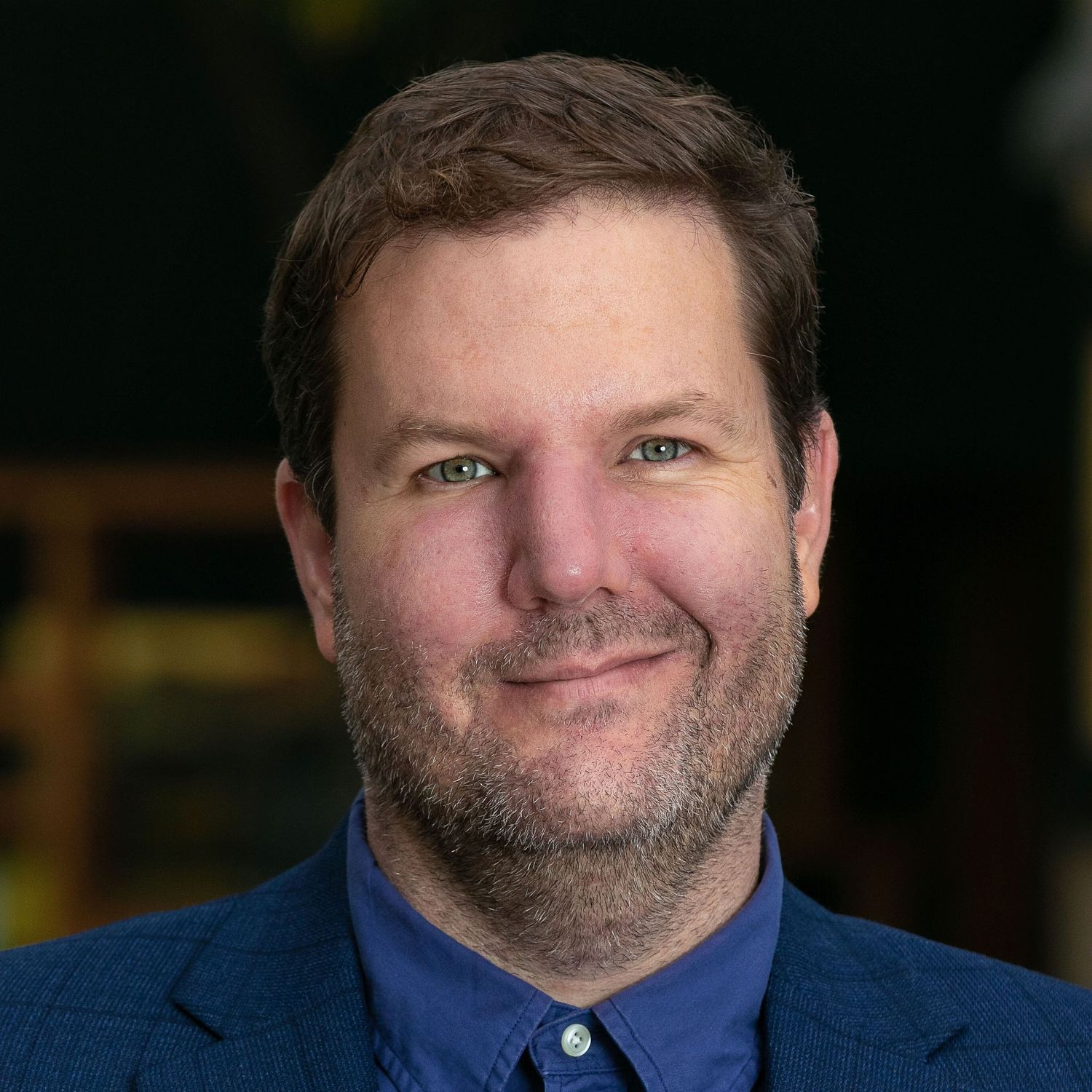 Headshot of a white man in a business professional suit.