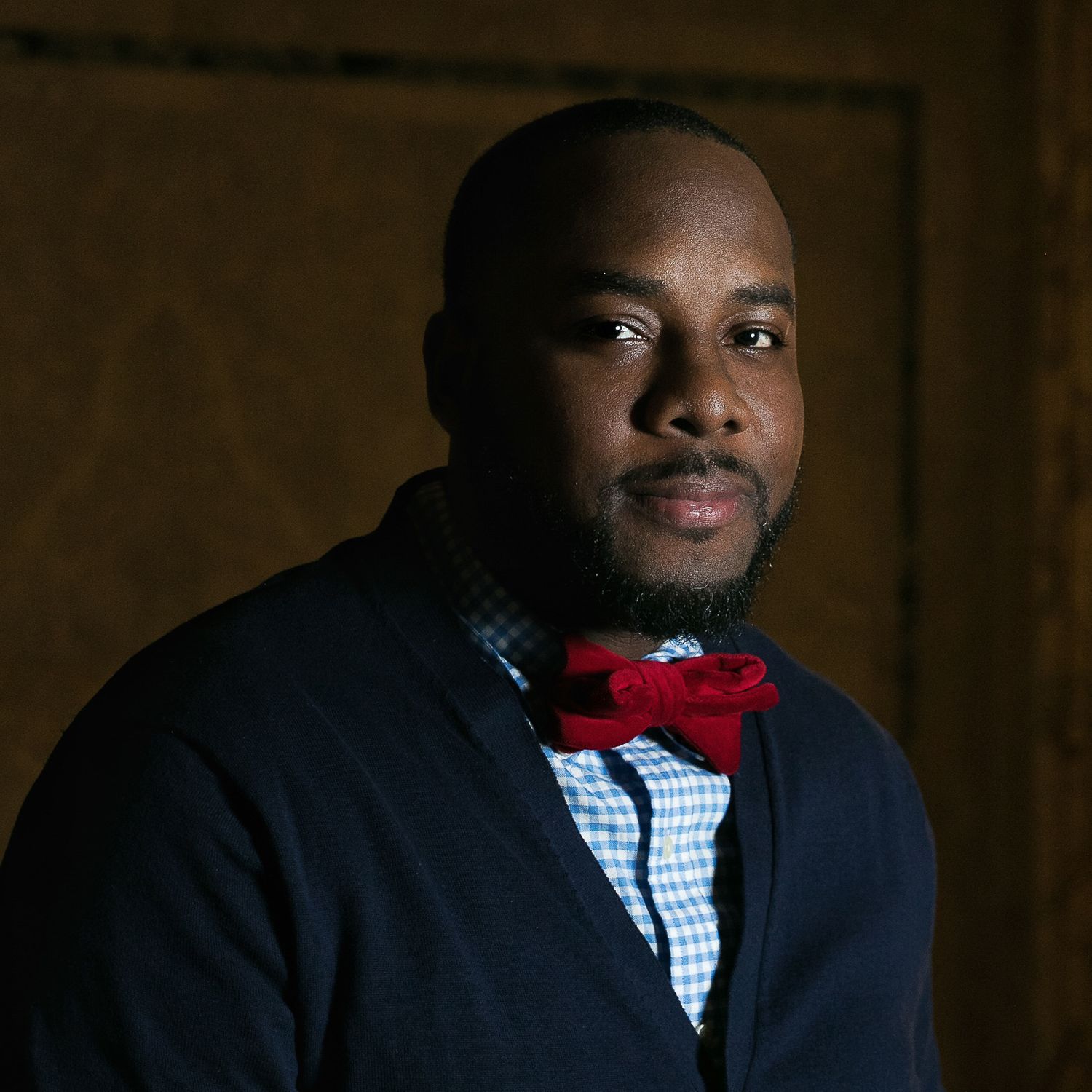 Moody portrait of a black man with light focused on one side of the face in the Fisher Building in Detroit.