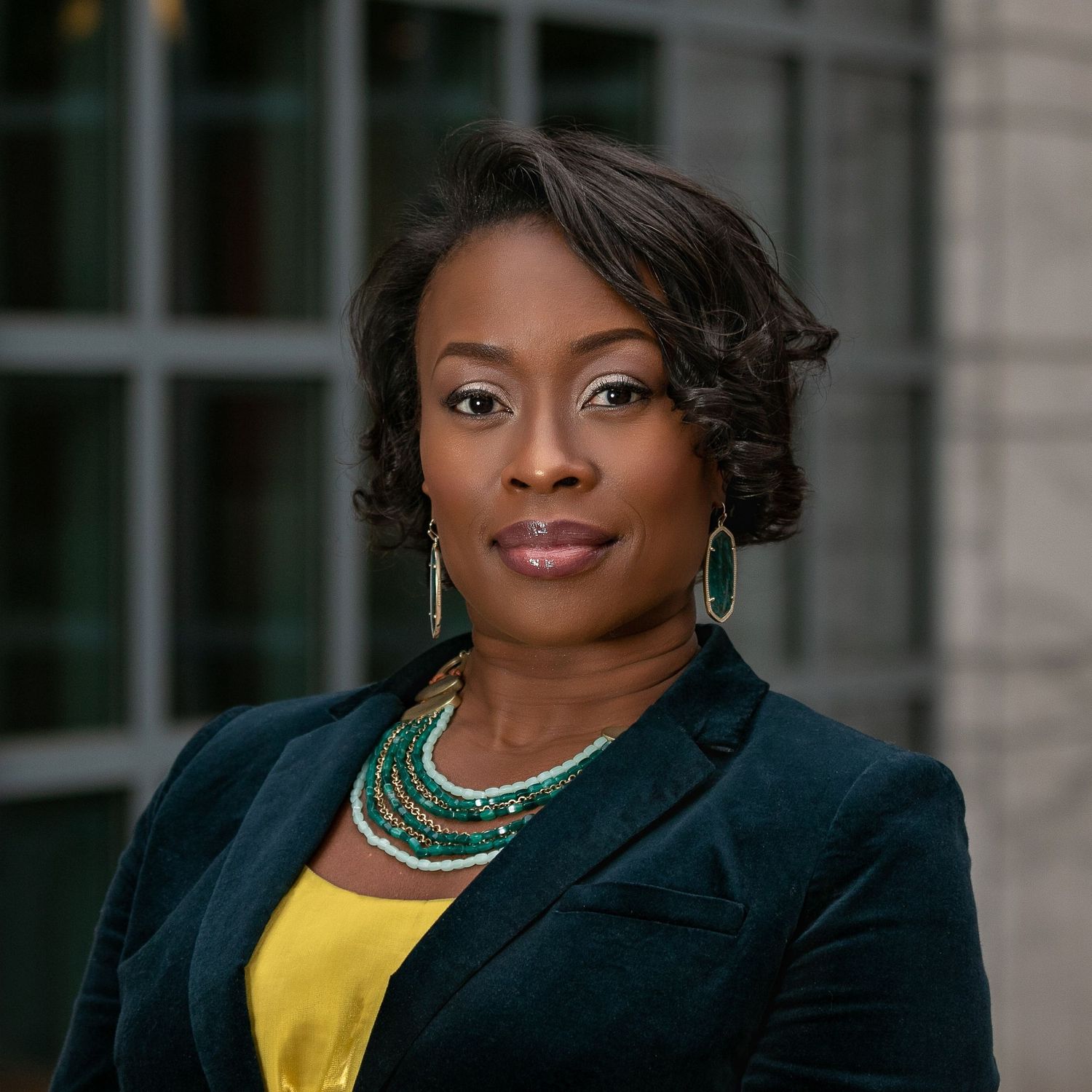 professional headshot of woman with environmental backdrop