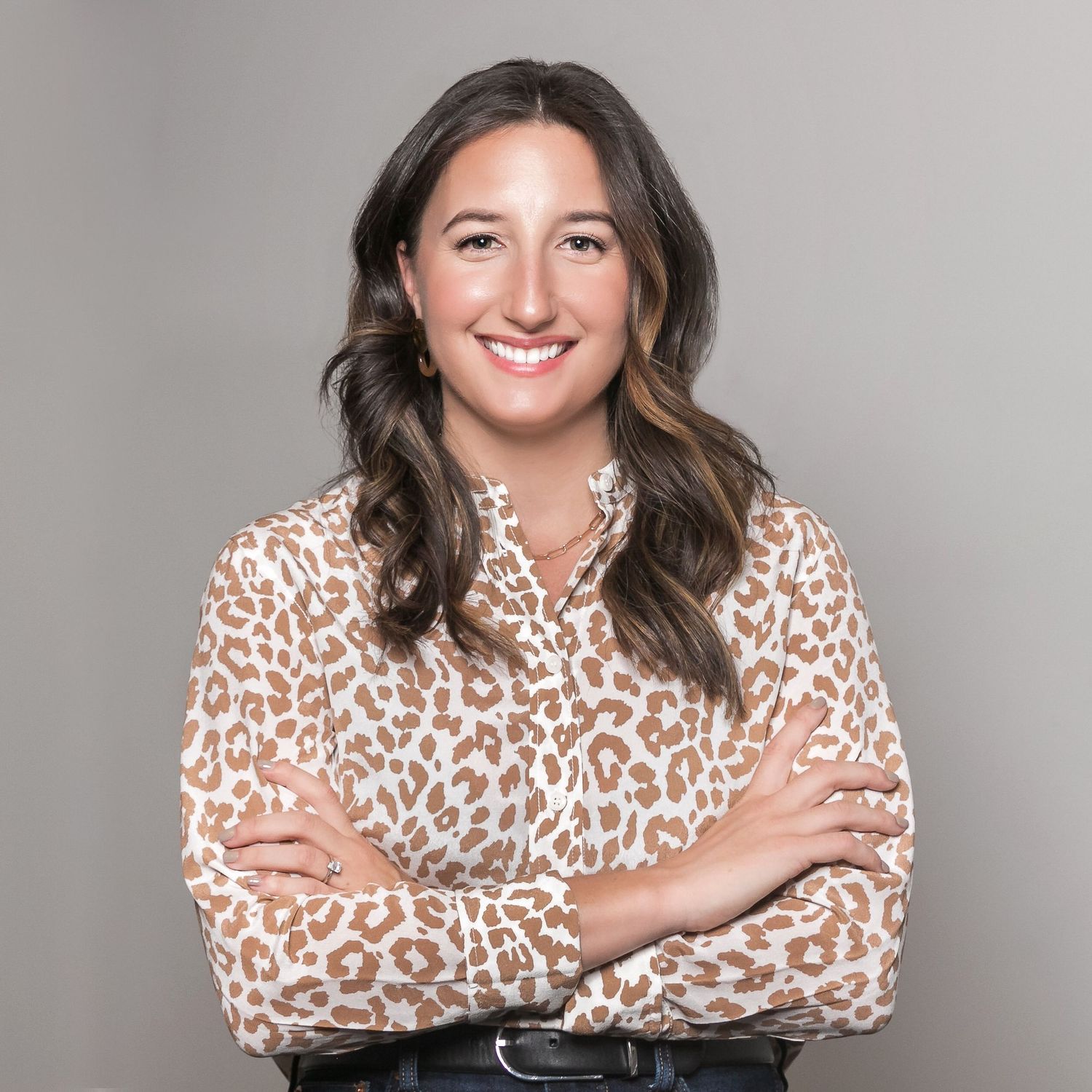Smiling women in business casual blouse with arms crossed