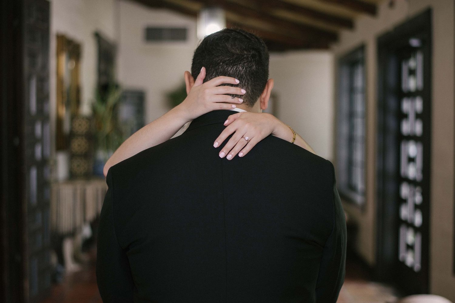 Beautiful bride's hands on grooms back. McAllen wedding photographer
