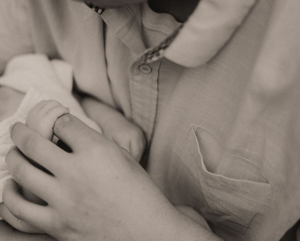 Close-up black and white intimate portrait showing gentle touch and connection.