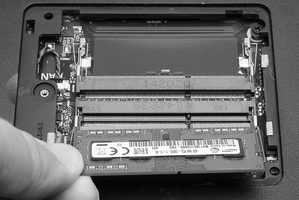 Inserting a typical laptop memory module (B+W)