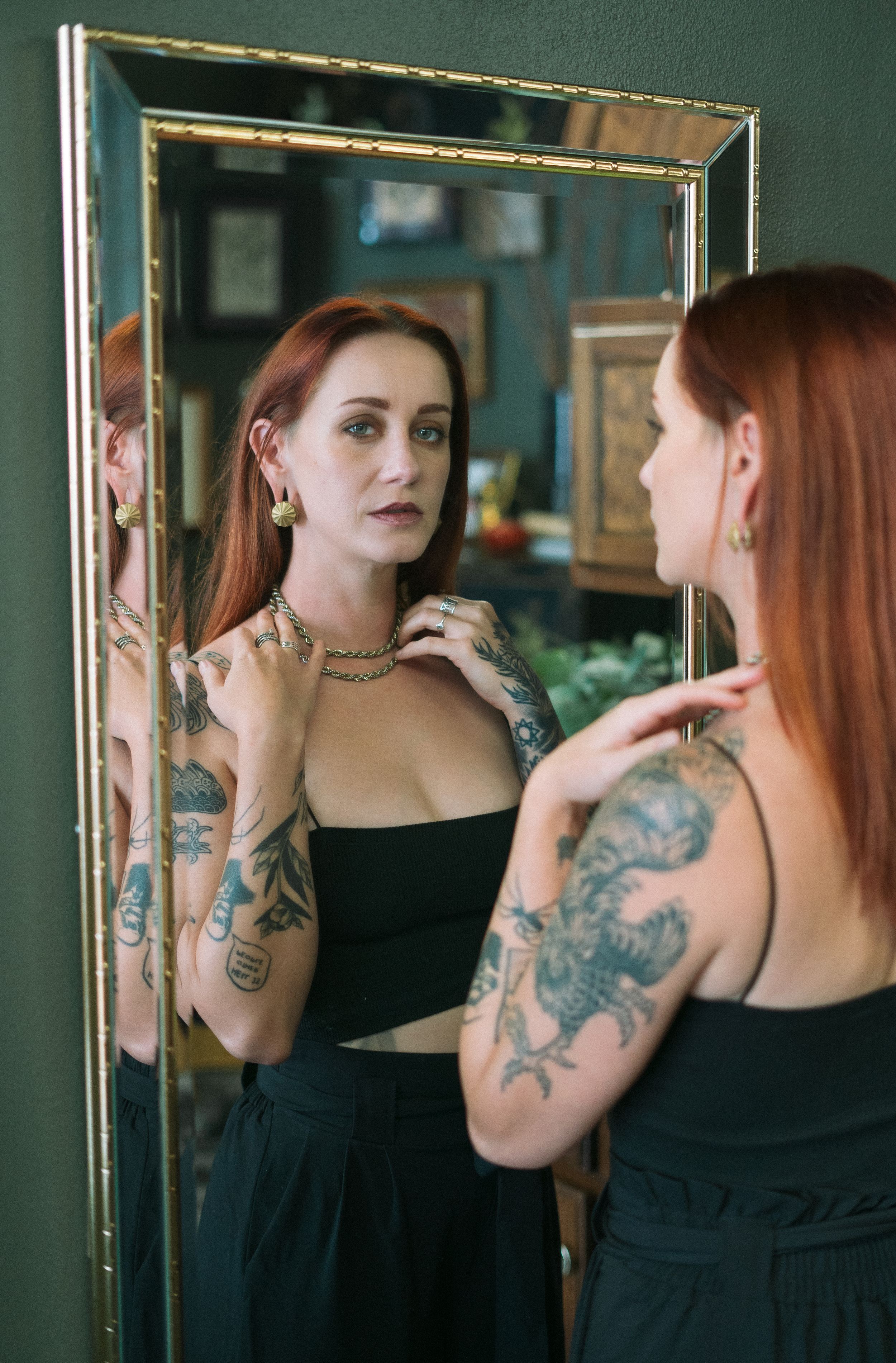tattooed girl in in miror