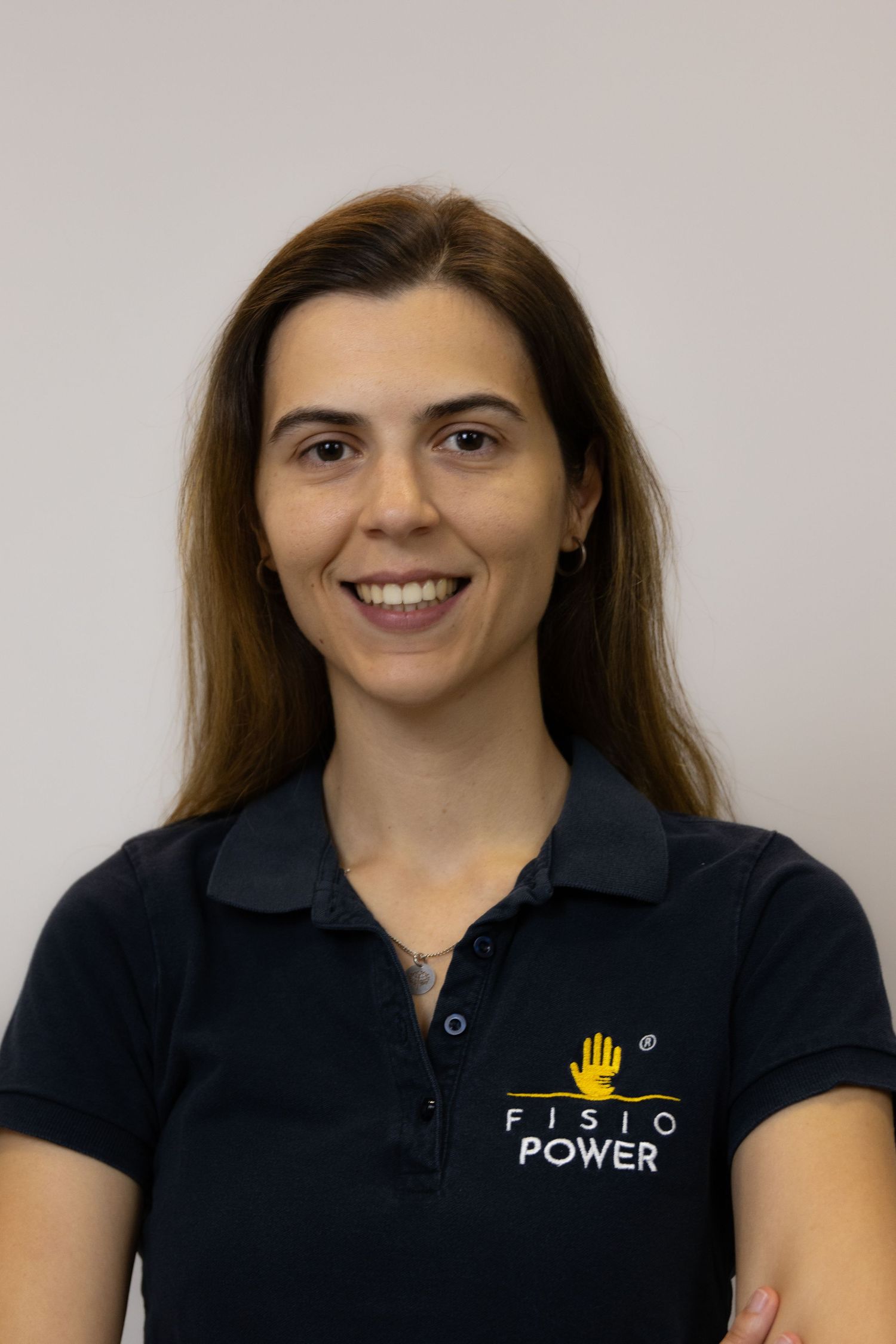 Professional headshots showing different poses in a navy polo shirt with company logo.