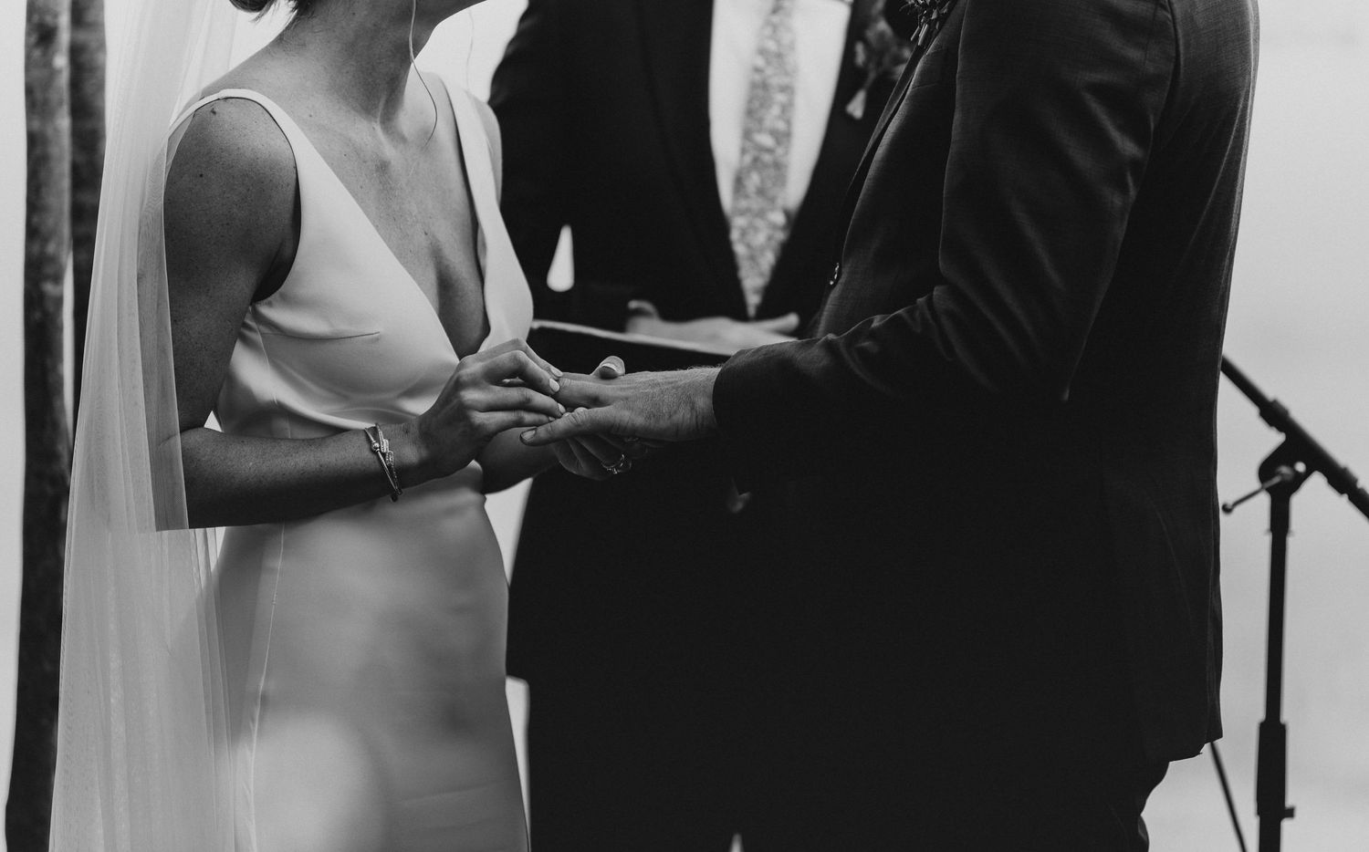 Black and white photograph capturing tender moments during a wedding ceremony.