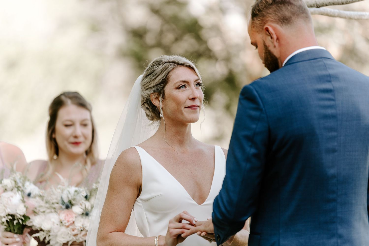 Candid moments shared between wedding couple during an outdoor ceremony.