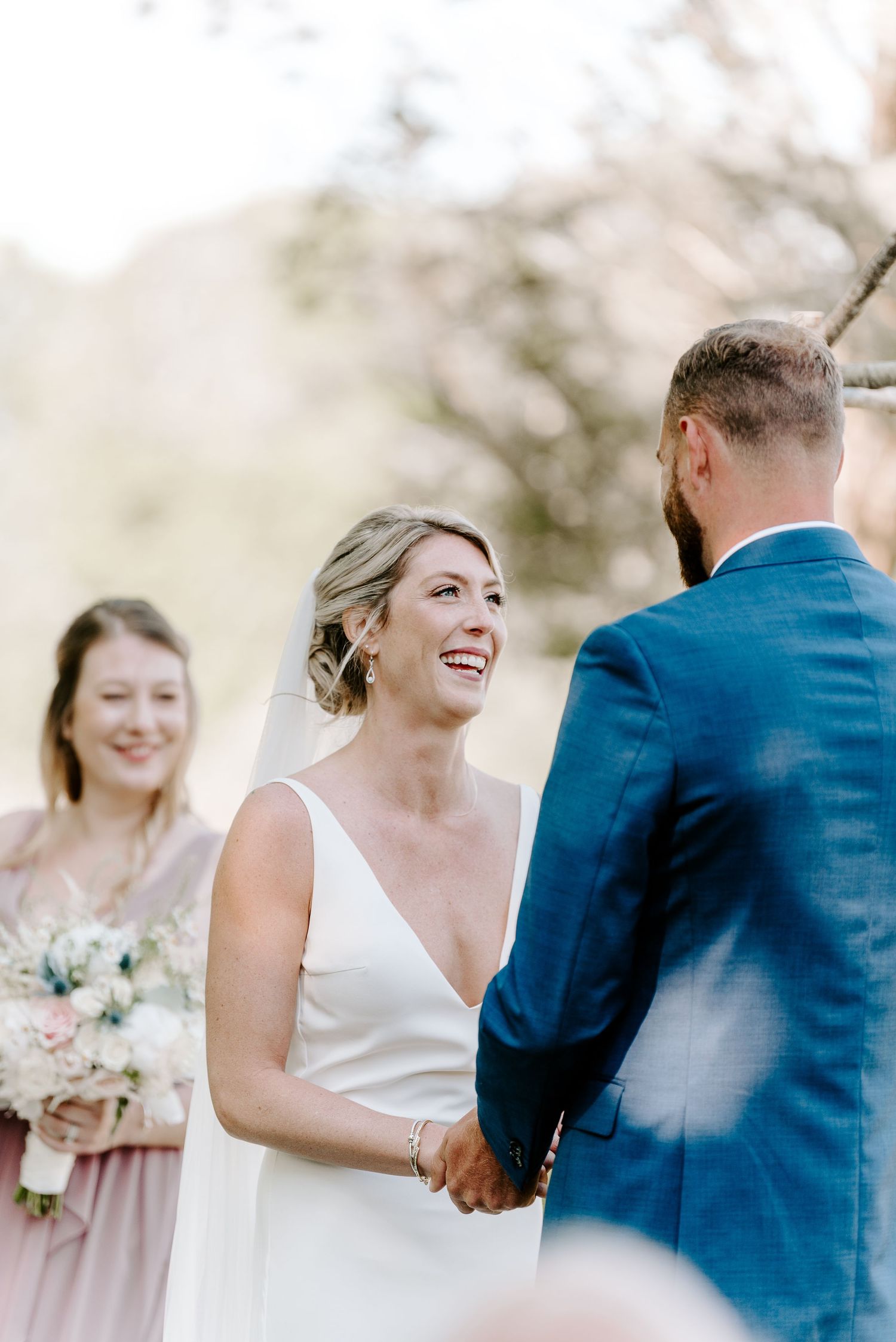 A joyful outdoor wedding ceremony moment captured in soft natural light.