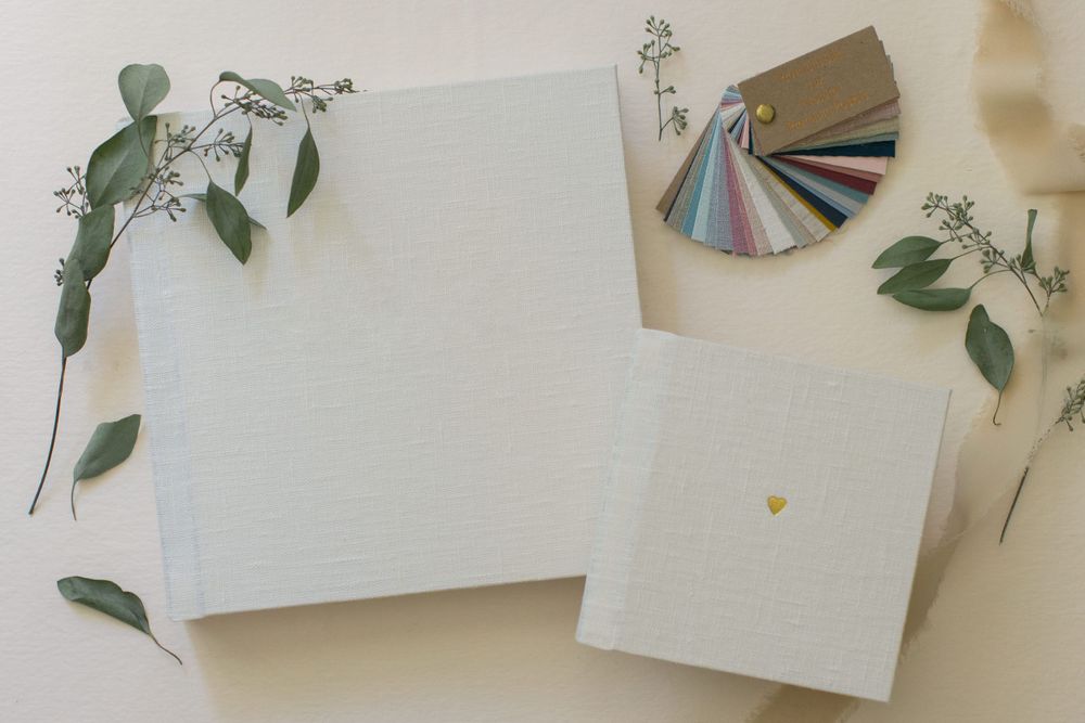 White stationery mockup with eucalyptus leaves and color swatches.