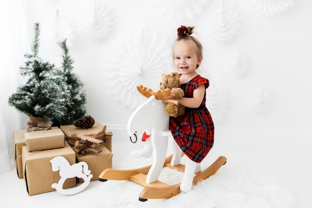 all white christmas photoshoot with a rocking horse Hereford