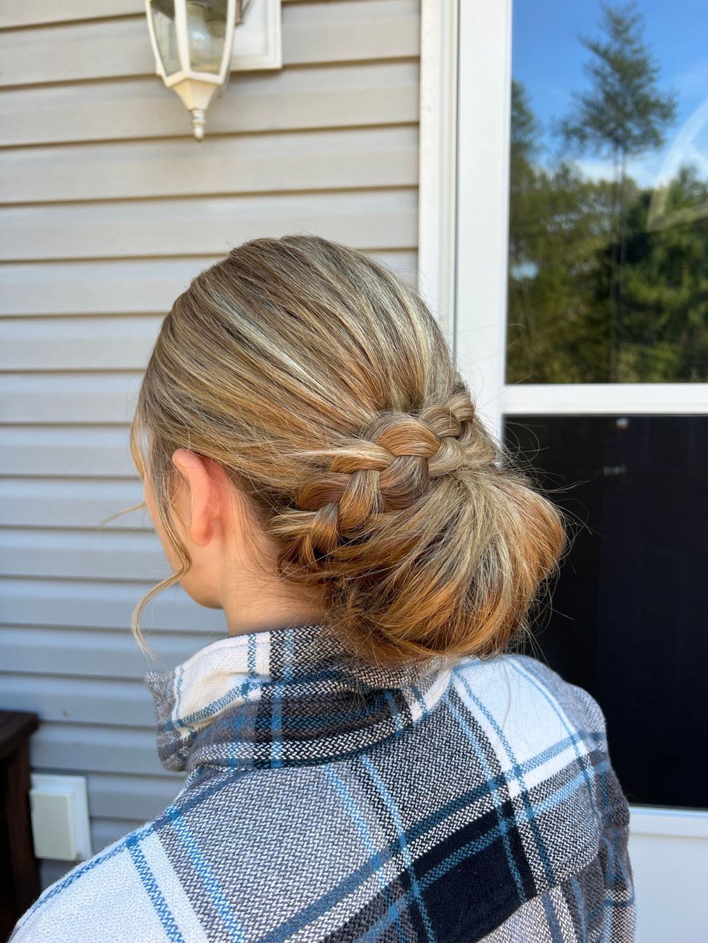 Hair styling progression showing intricate braiding against white siding exterior.