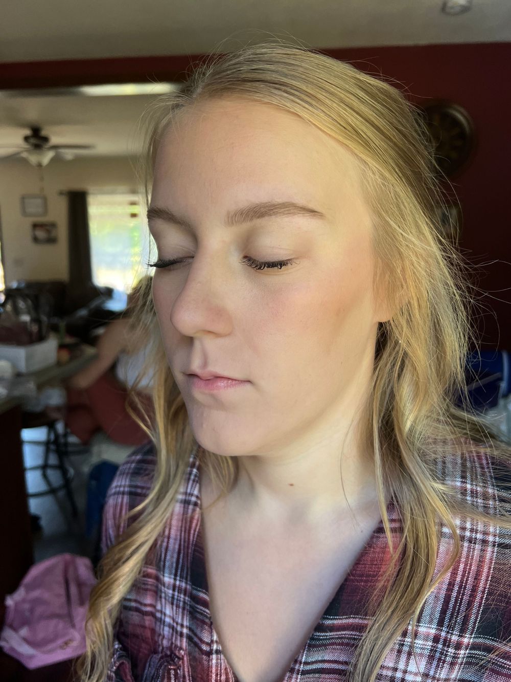 Close-up profile shots with blonde hair and plaid shirt in indoor lighting.