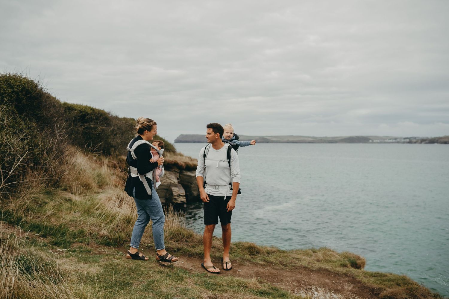 A family pauses during their coastal hike to enjoy scenic ocean views.