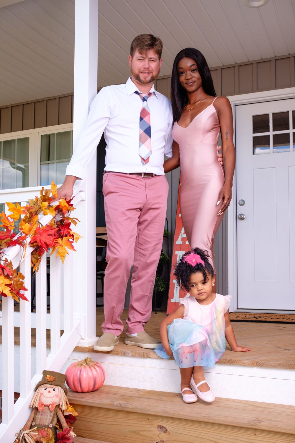 Family Photography: Beautiful family portrait of three standing on a porch