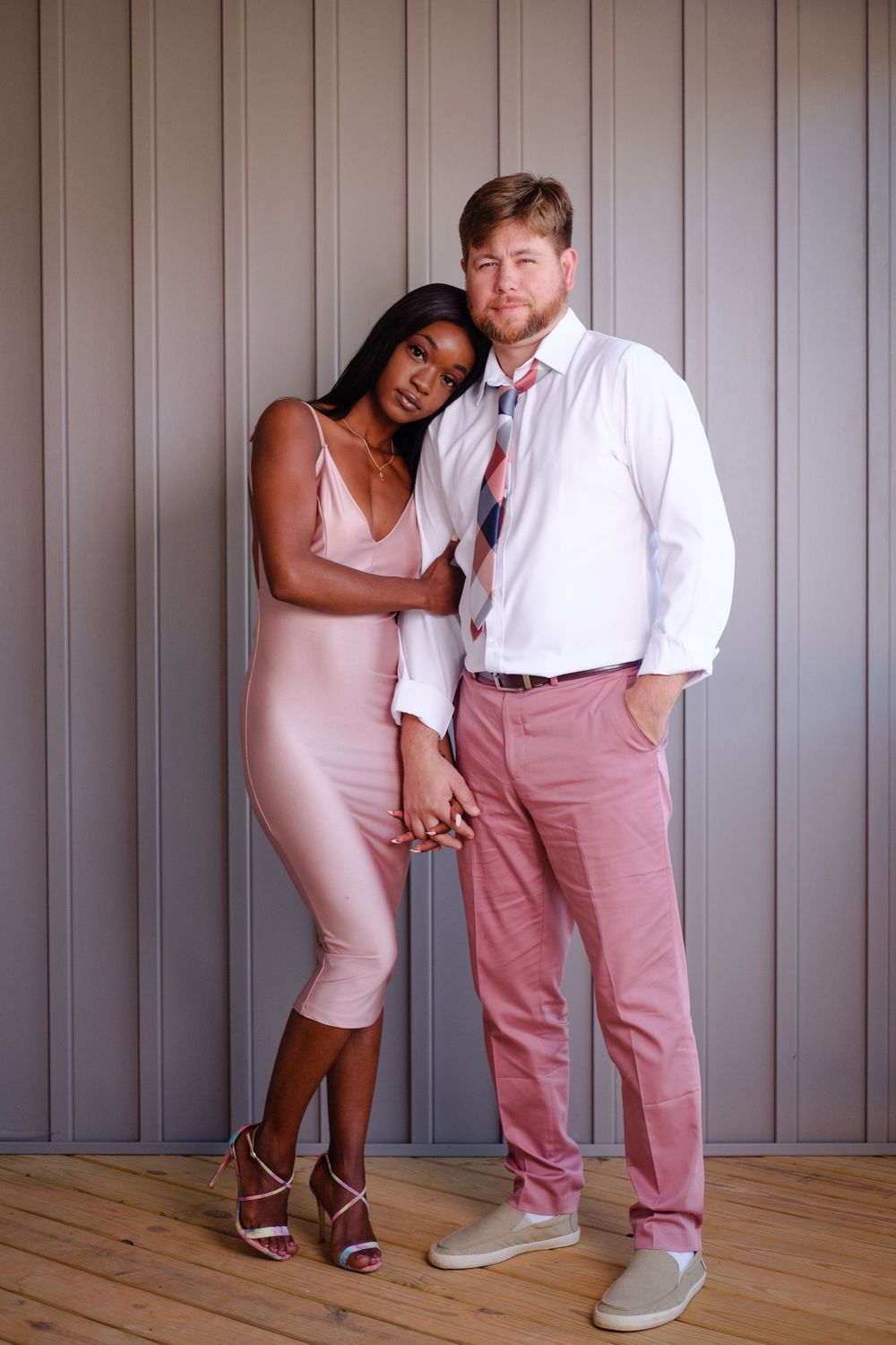 Family Photography: Amazing portrait of a happy couple standing by a wall