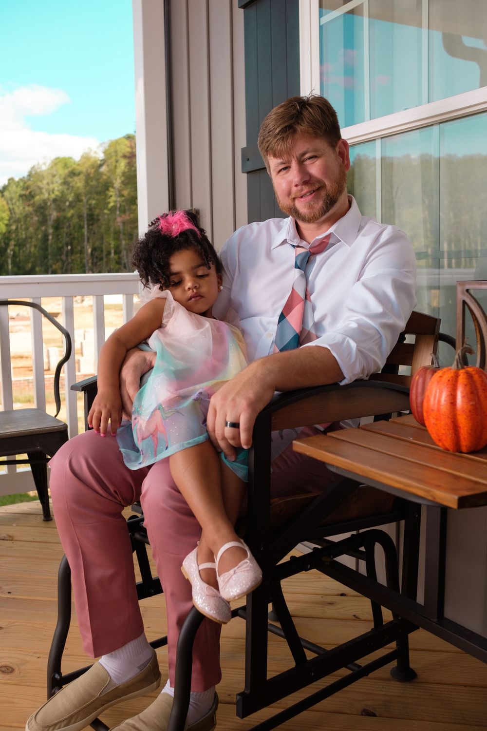 Family Photography: Beautiful Portrait of a father and daughter sitting on a porch