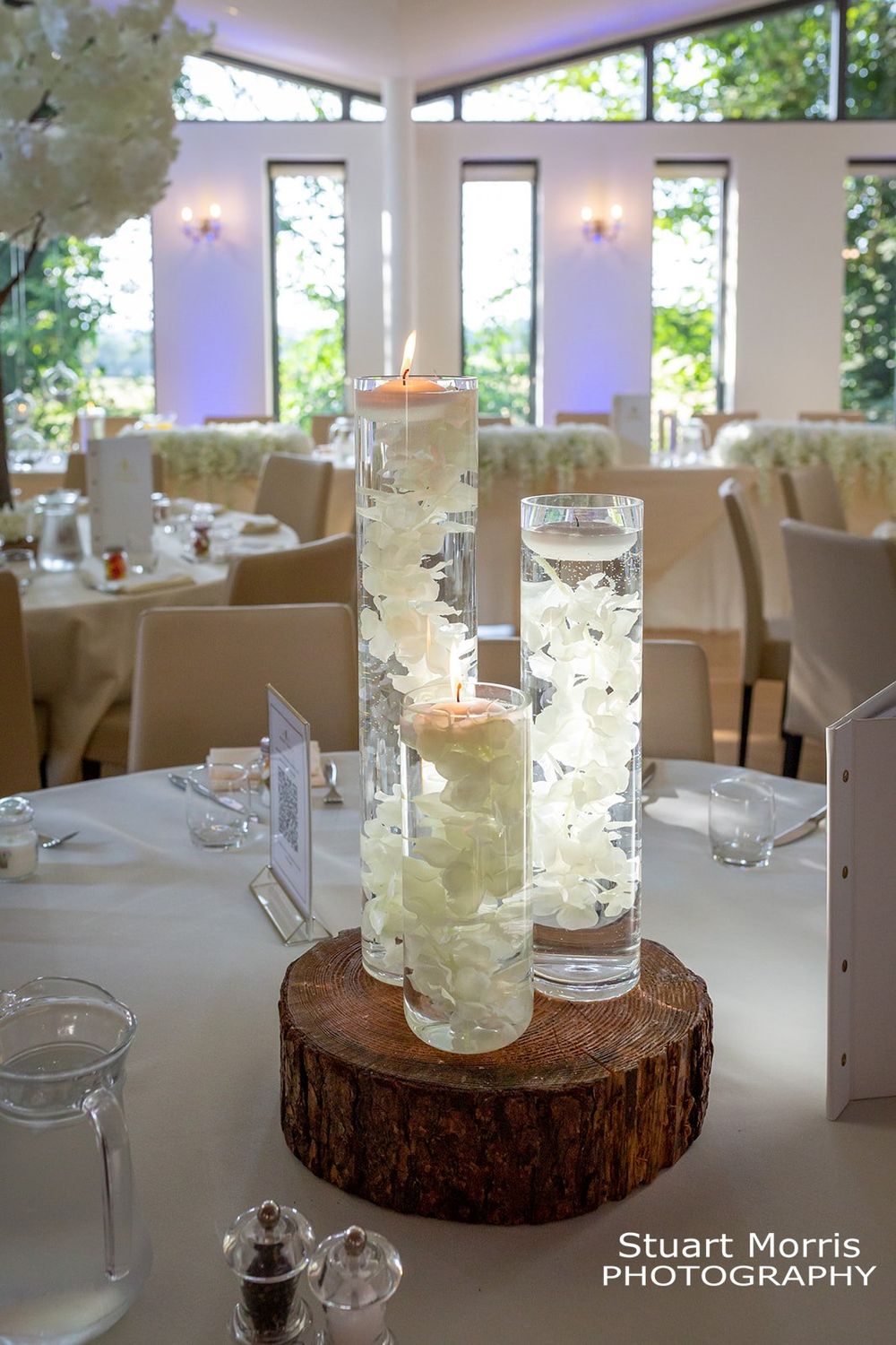 Floating candles and flowers in vases Wedding decor. West tower country house wedding photographer.