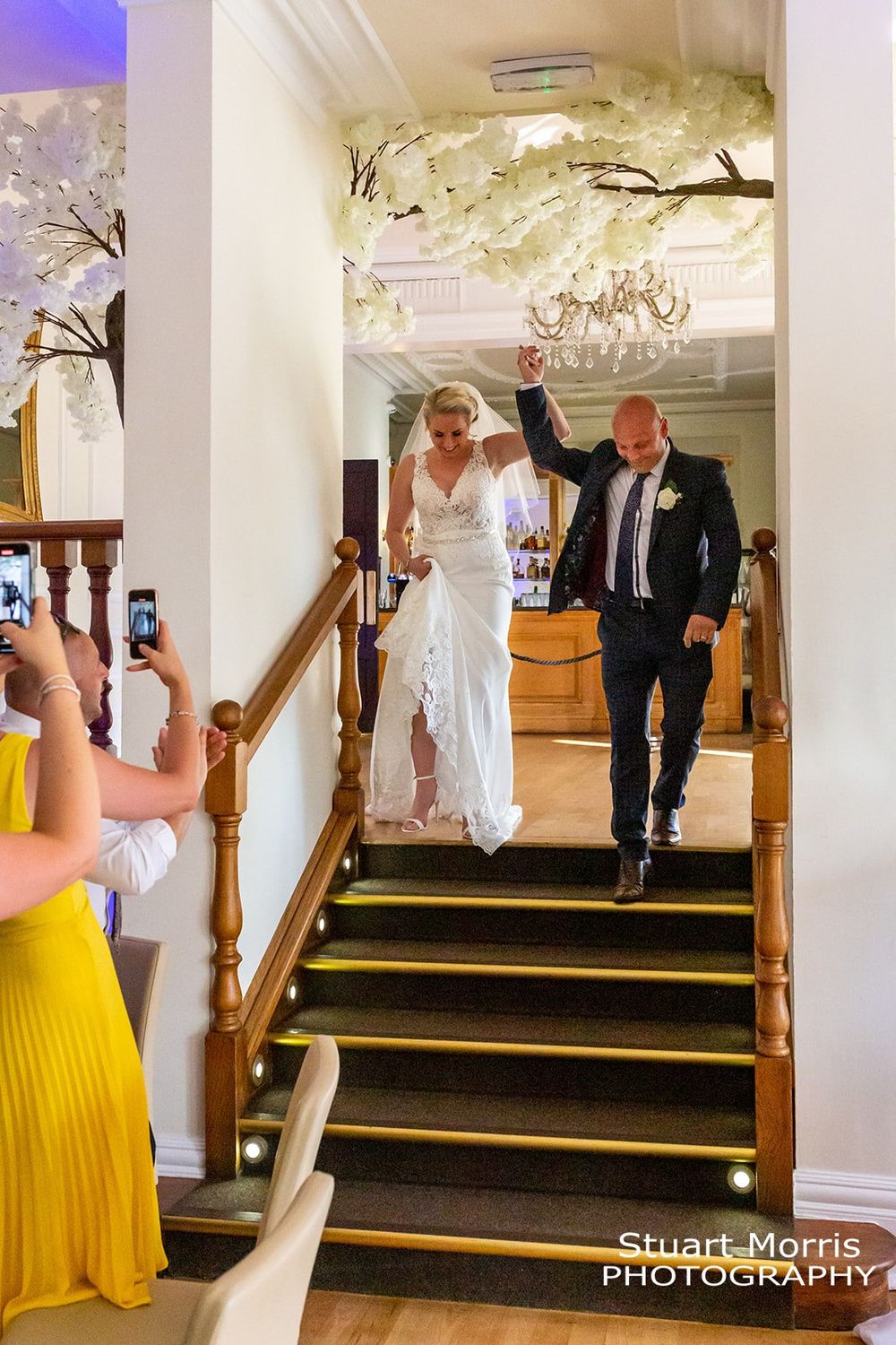 Bride and groom walk down the steps to the ballroom at west tower. Lancashire wedding photographer.