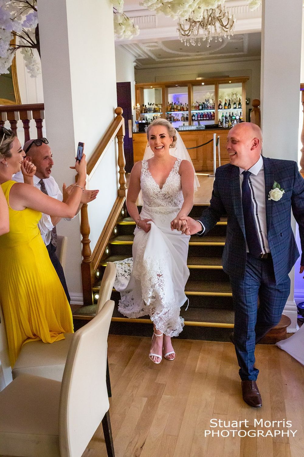 Bride and groom enter the west tower ballroom before the wedding breakfast. Country house wedding photography.