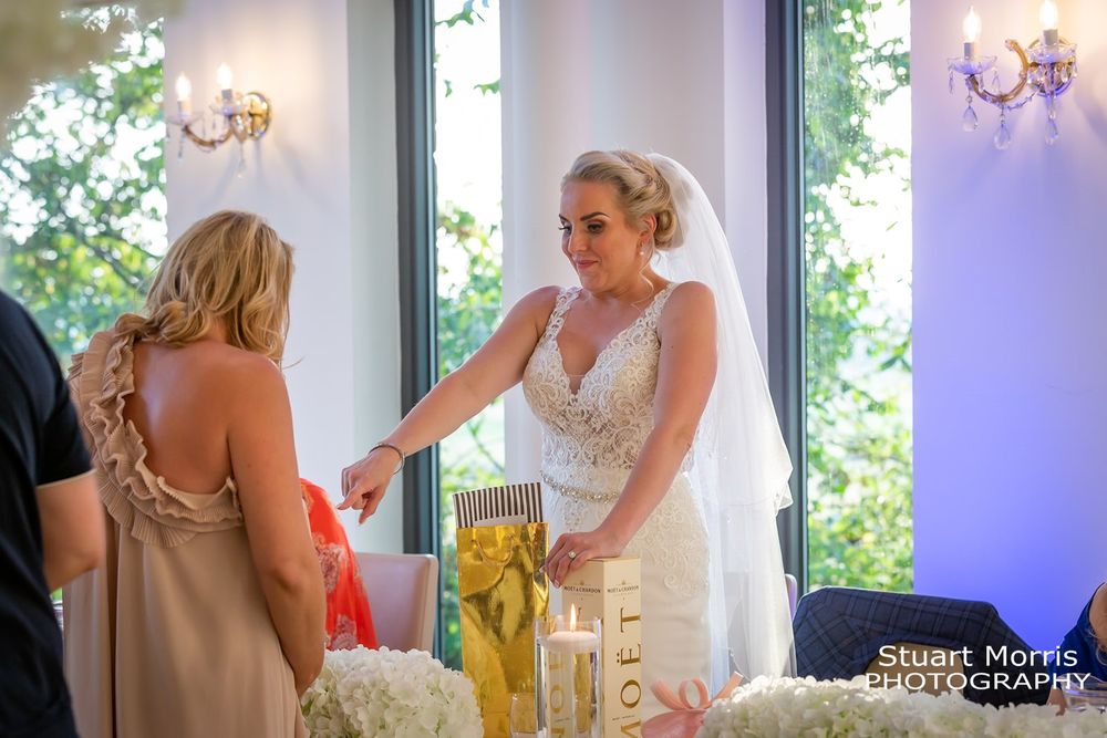 Bride chats to wedding guest during the wedding breakfast at west tower country house wedding venue.
