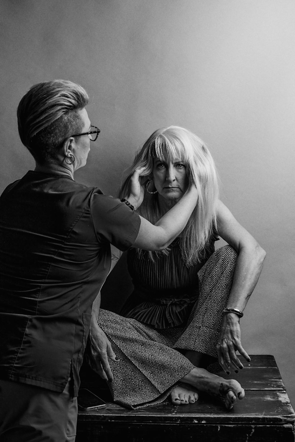 Artistic portrait sequence showing intimate interaction against grey background.