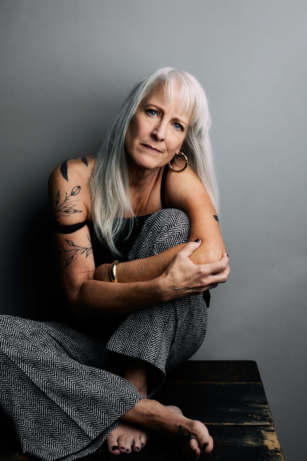 Expressive portrait series featuring silver hair and polka dot dress against grey backdrop.